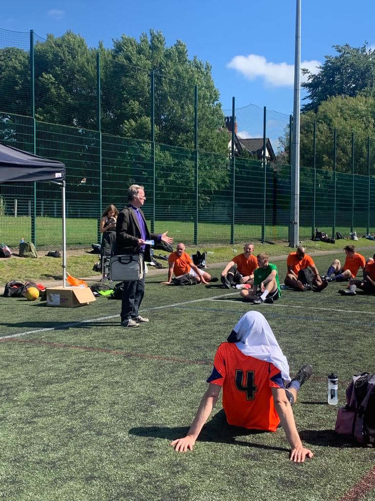 Listening to the Gospel at football tournament